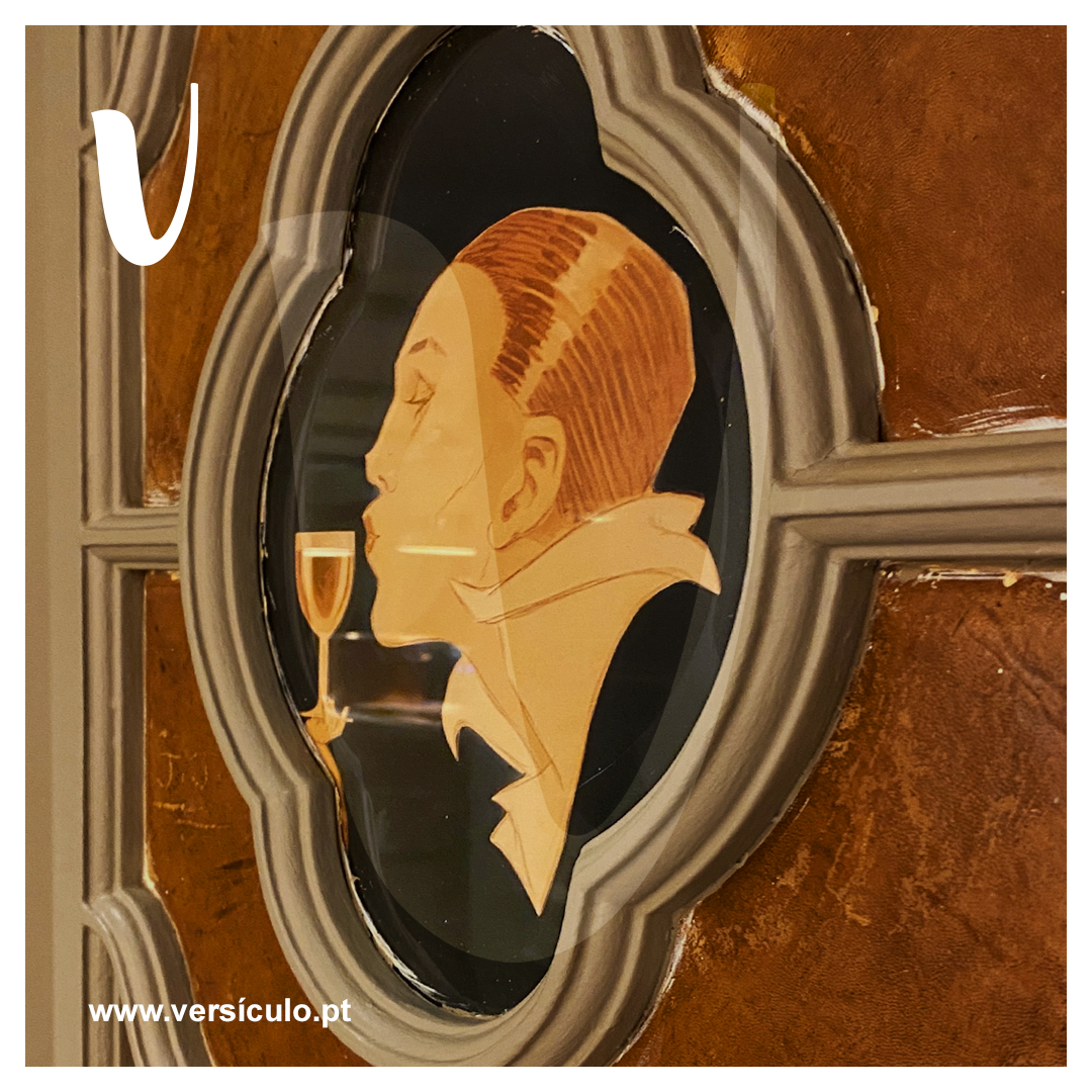 Vintage glass portrait ornament set in the restaurant's wooden doorway